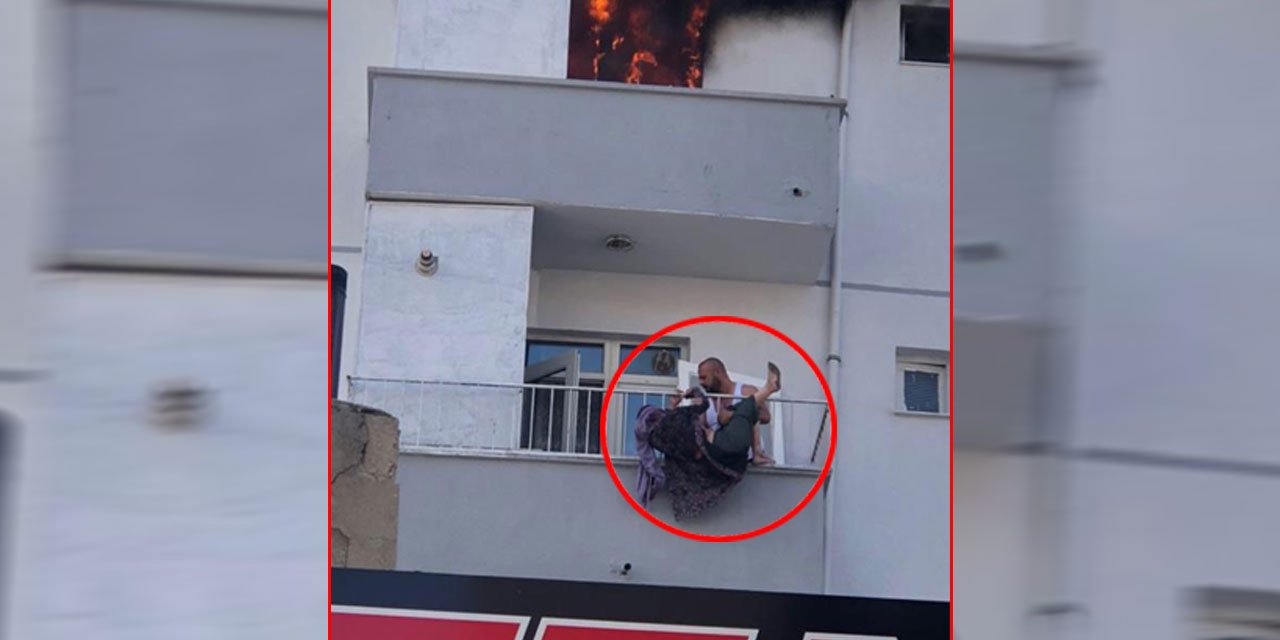 Yanan evden atlayan kadını komşusu havada yakaladı
