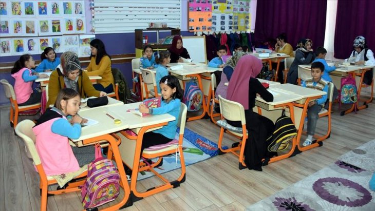 Öğrenciler ev ortamına dönüştürülen sınıfta ders yapıp velileriyle kitap okuyor